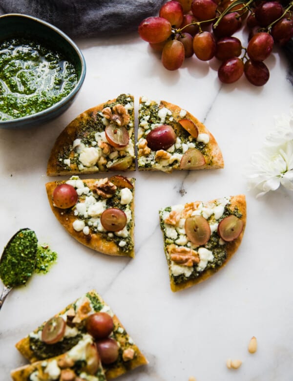 pita pizza with kale pesto on a marble white board