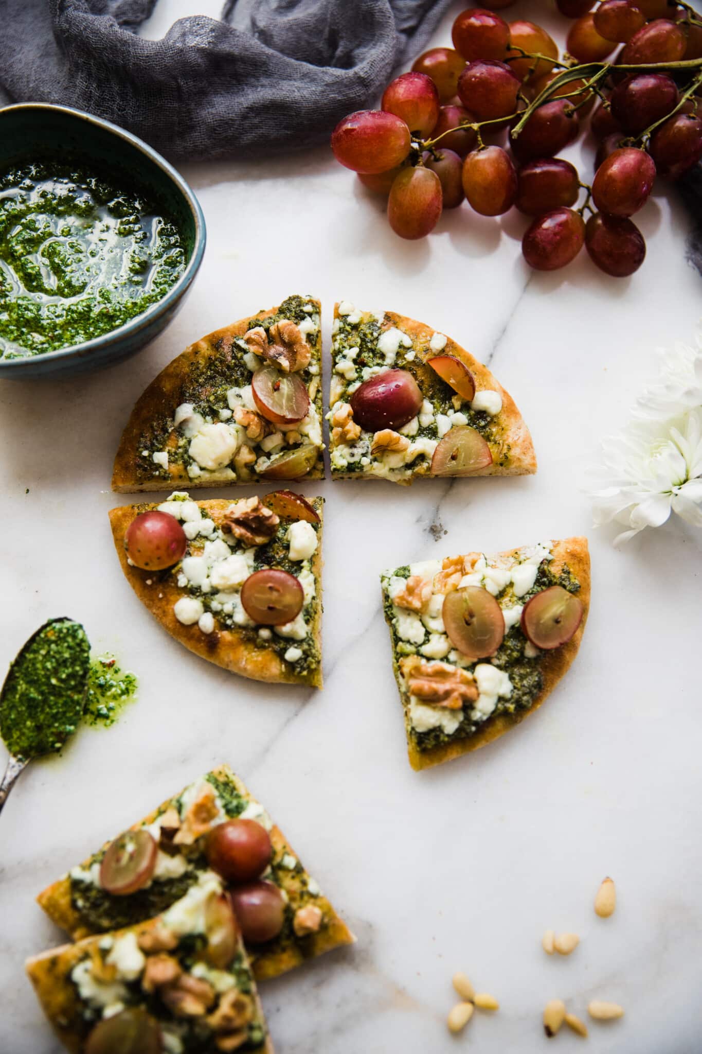 pita pizza with kale pesto on a marble white board