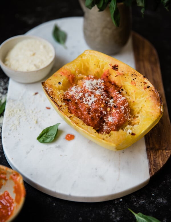 a cooked spaghetti squash on a marble board