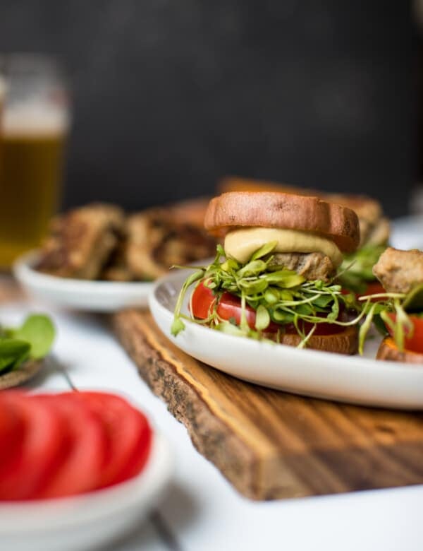 a turkey burger on a white plate with sweet potato