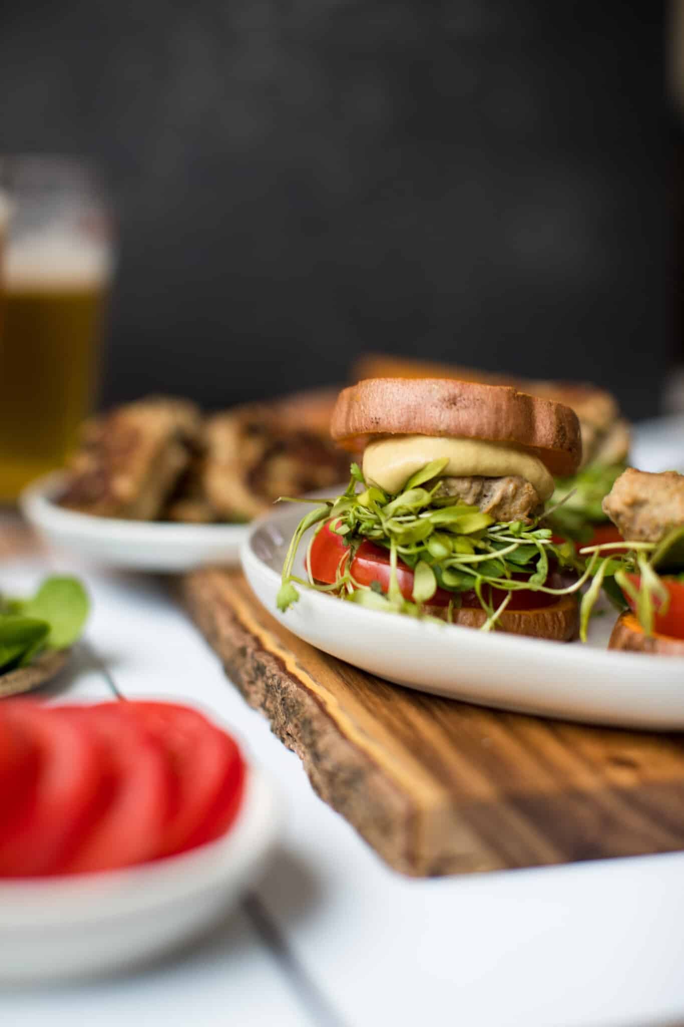 a turkey burger on a white plate with sweet potato