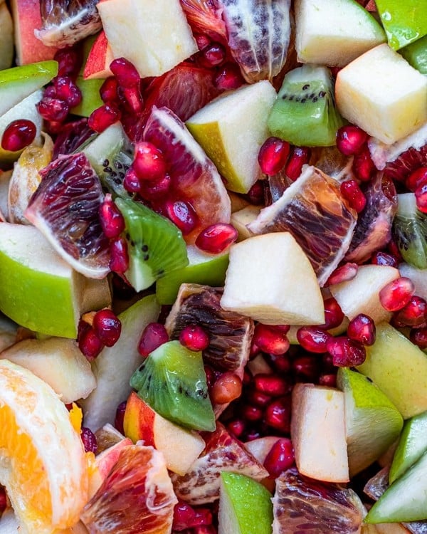 fruit mixed together - pomegranates, blood oranges, apples