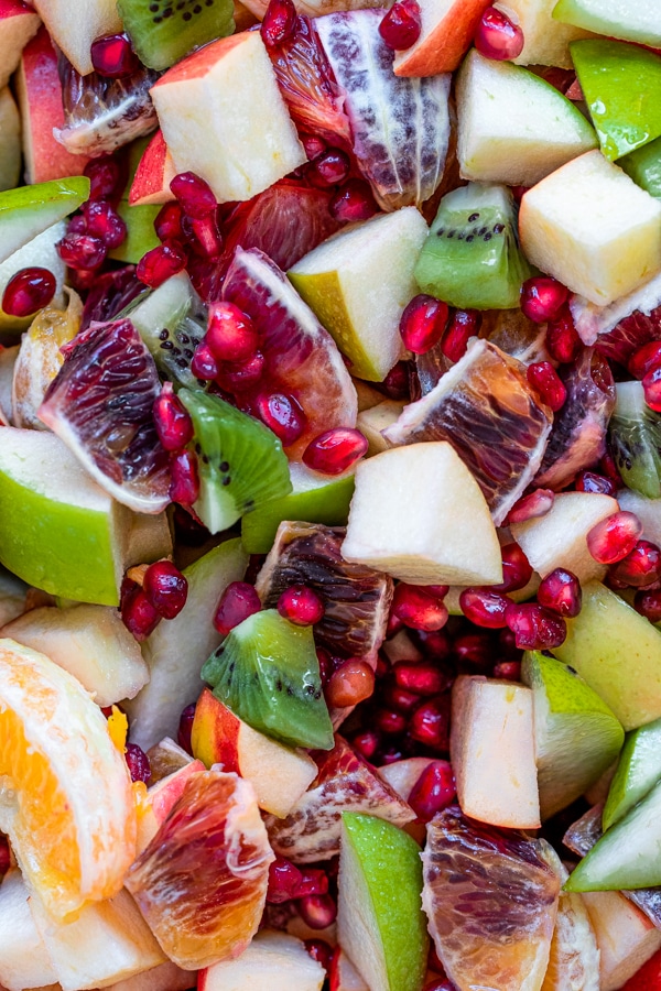 fruit mixed together - pomegranates, blood oranges, apples