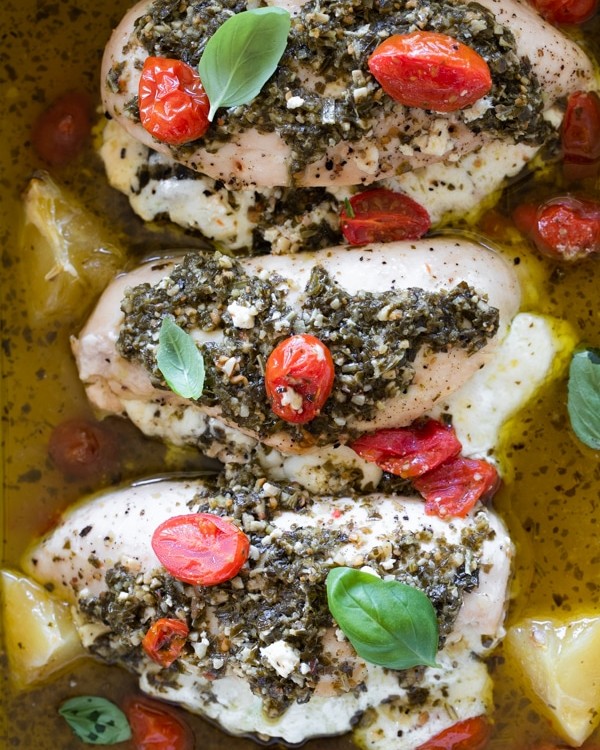 chicken topped with pesto in a baking dish