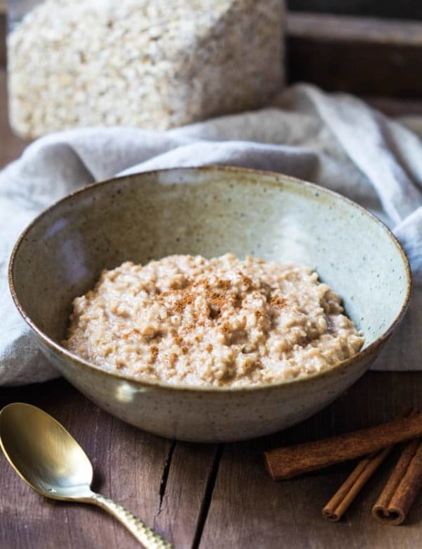 Oatmeal in a bowl on a wooden board