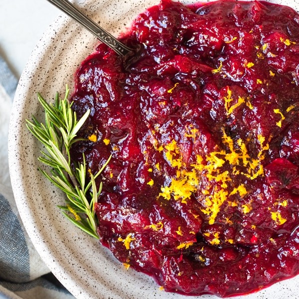 cranberry sauce in a bowl topped with orange zest