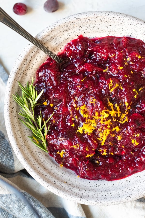 cranberry sauce in a bowl topped with orange zest