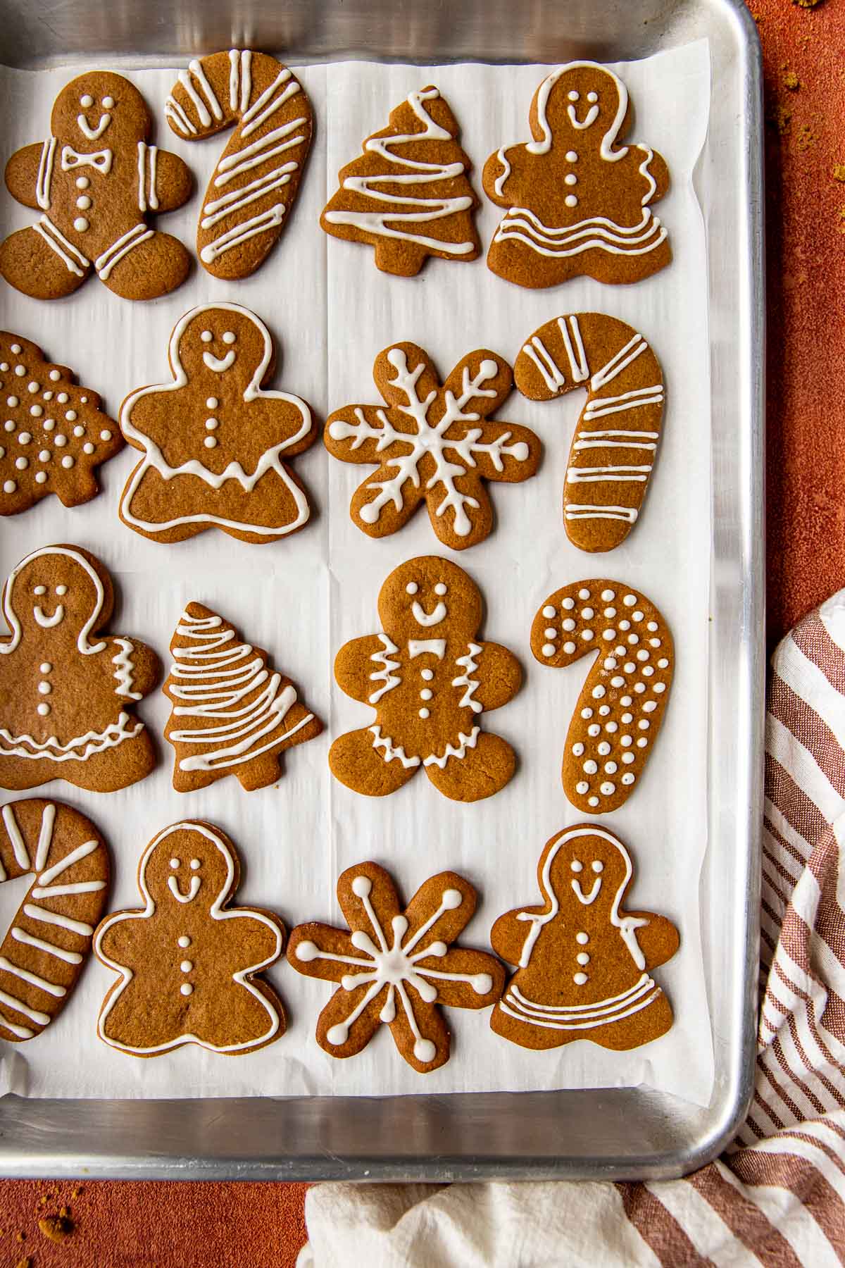 gingerbread cookies on a cookie sheet decorated with icing. 