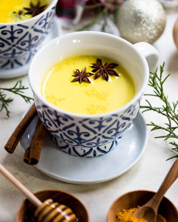 turmeric milk in a mug with star anise and cinnamon
