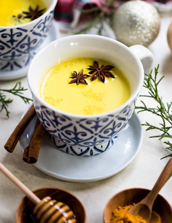 turmeric milk in a mug with star anise and cinnamon
