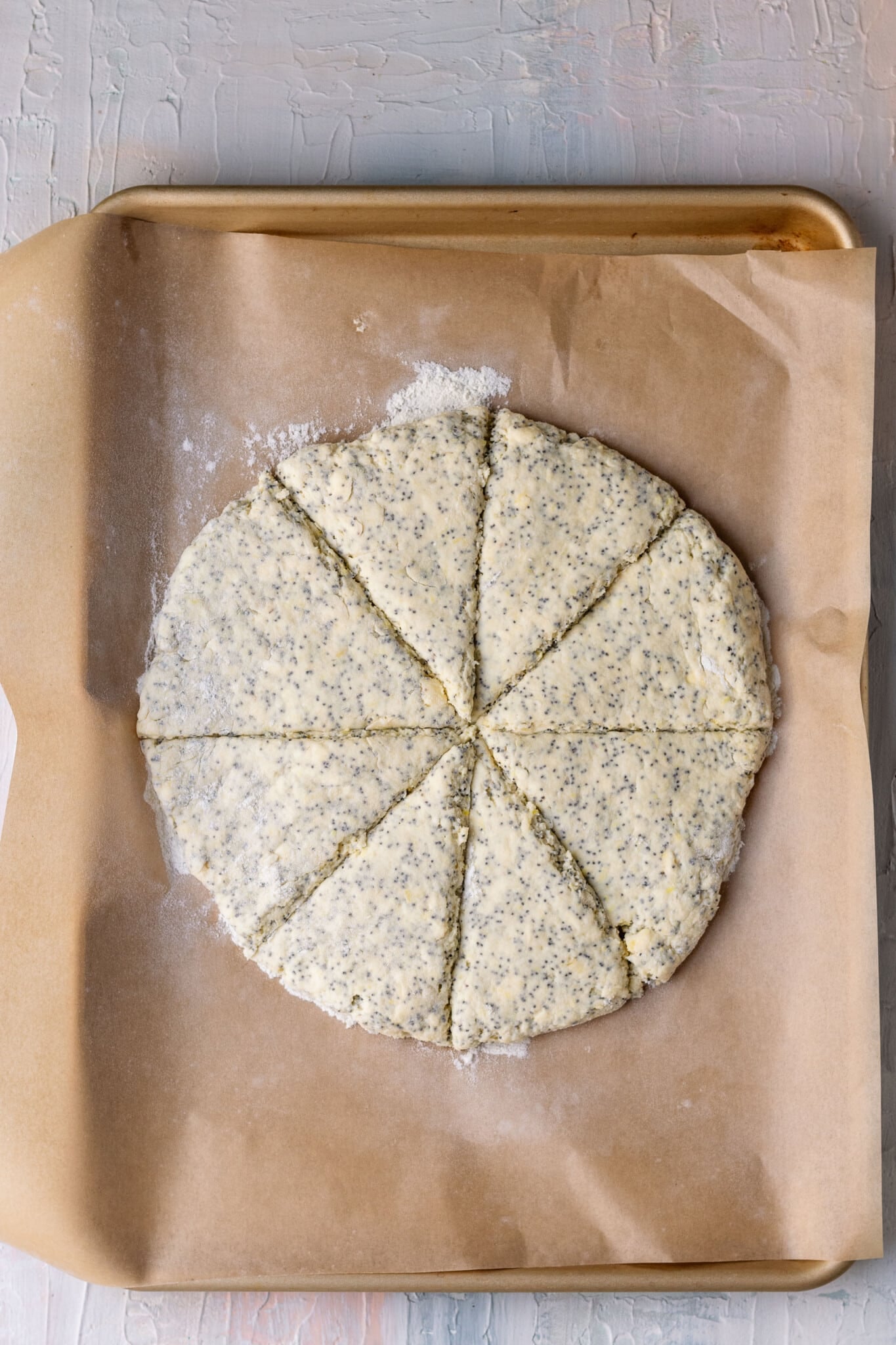 scones on a baking sheet lined with parchment paper cut into 8 triangles