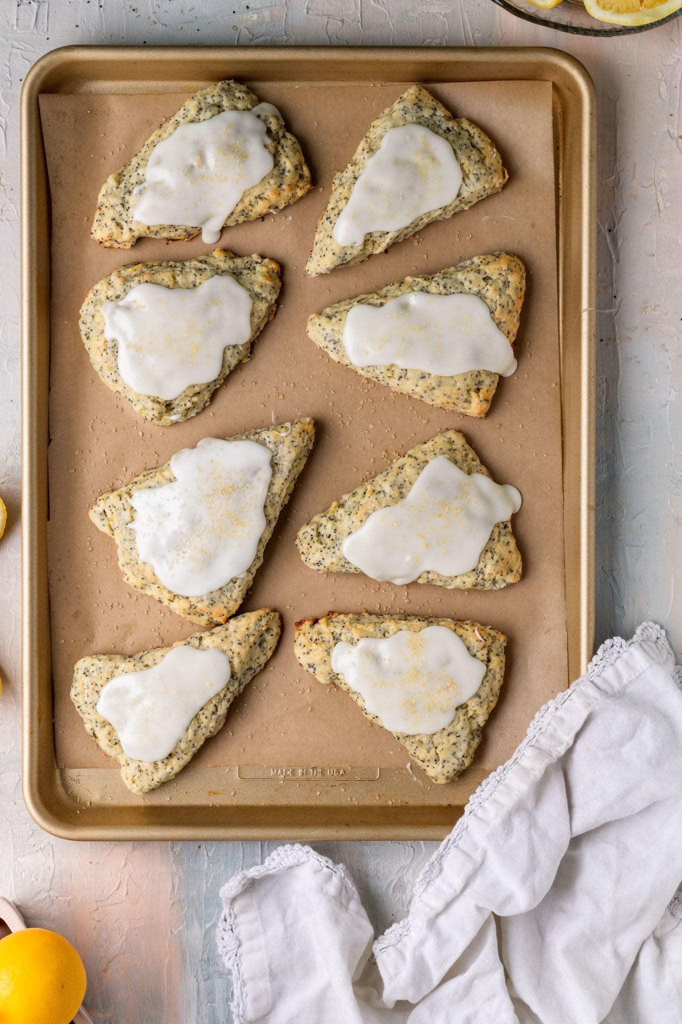 scones on a baking sheet topped with glaze