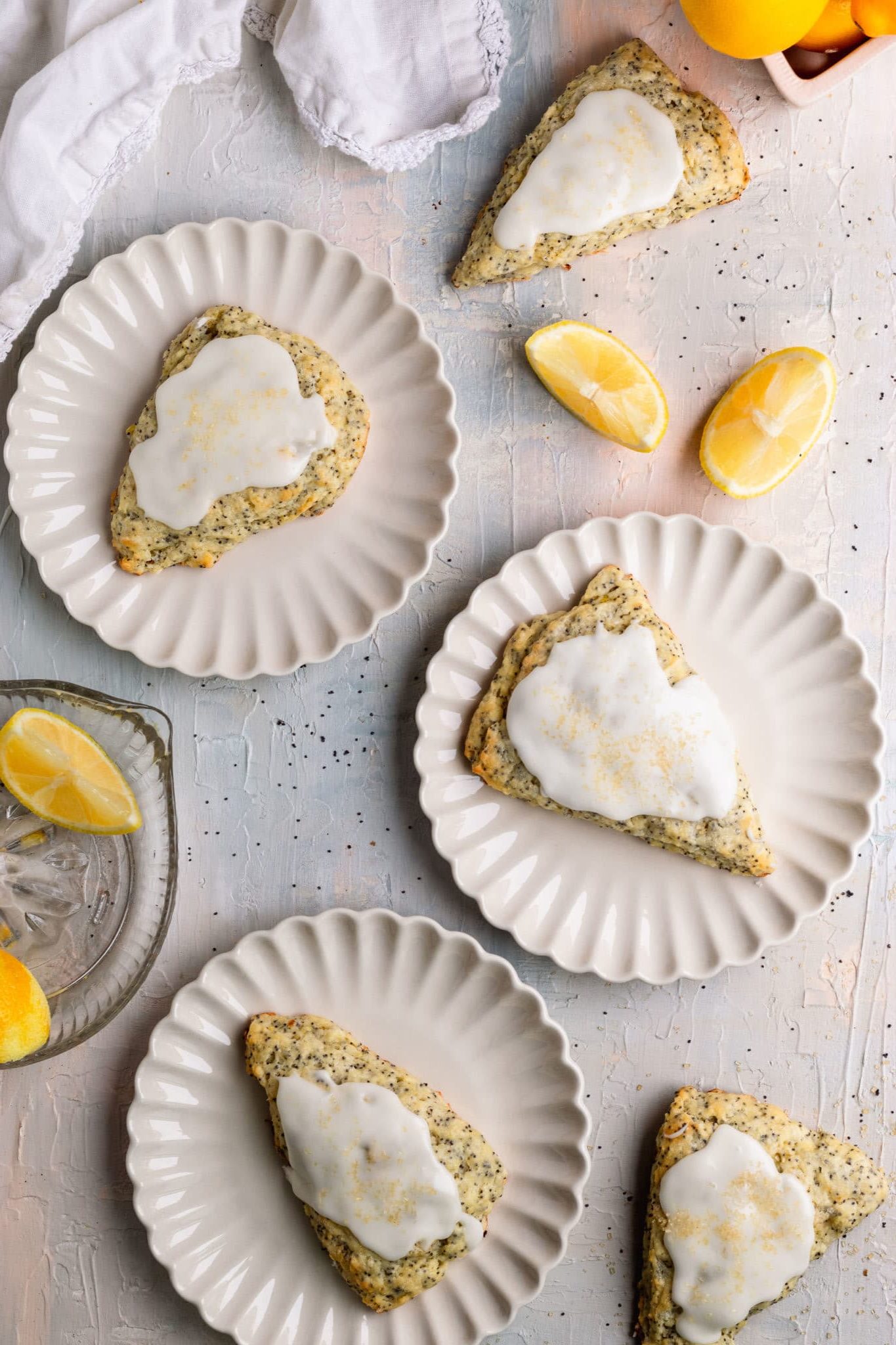 scones on white plates topped with glaze