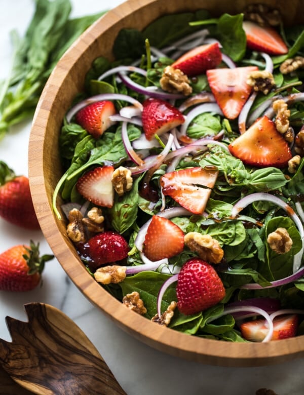 spinach in a wood bowl with stawberries