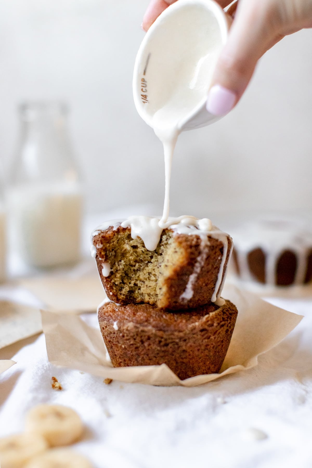 frosting being poured on muffins