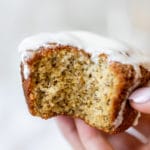 a womans hand holding a muffin