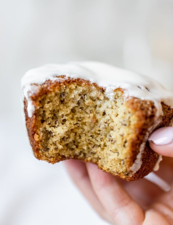 a womans hand holding a muffin