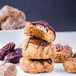 Pumpkin Cookies stacked on top of each other drizzled with dark chocolate.