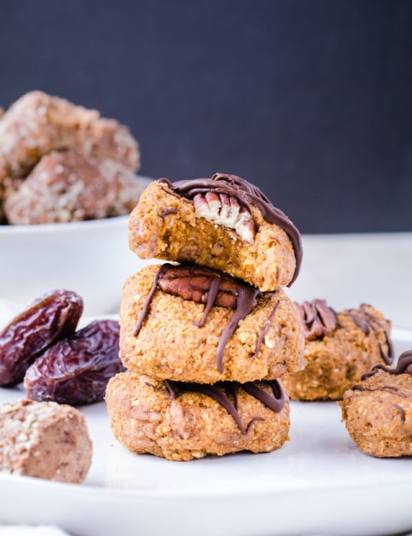 Pumpkin Cookies stacked on top of each other drizzled with dark chocolate.