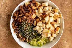 bread, meat, spices, mushroom, and onions in a bowl 