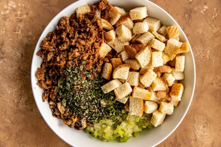 bread, meat, spices, mushroom, and onions in a bowl 