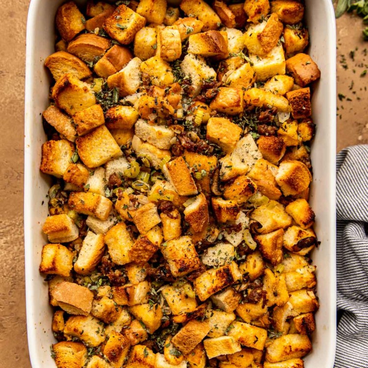 overhead shot of sausage mushroom stuffing in a white casserole dish
