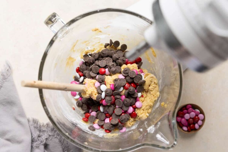 chocolate chips and valentines m&ms in a glass mixing bowl.
