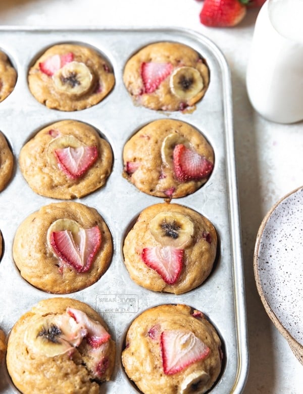 strawberry banana muffins in a muffin tin