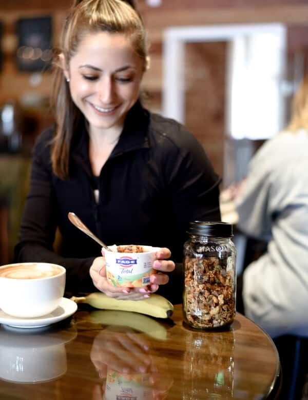 me sitting in a coffee shop with a FAGE yogurt