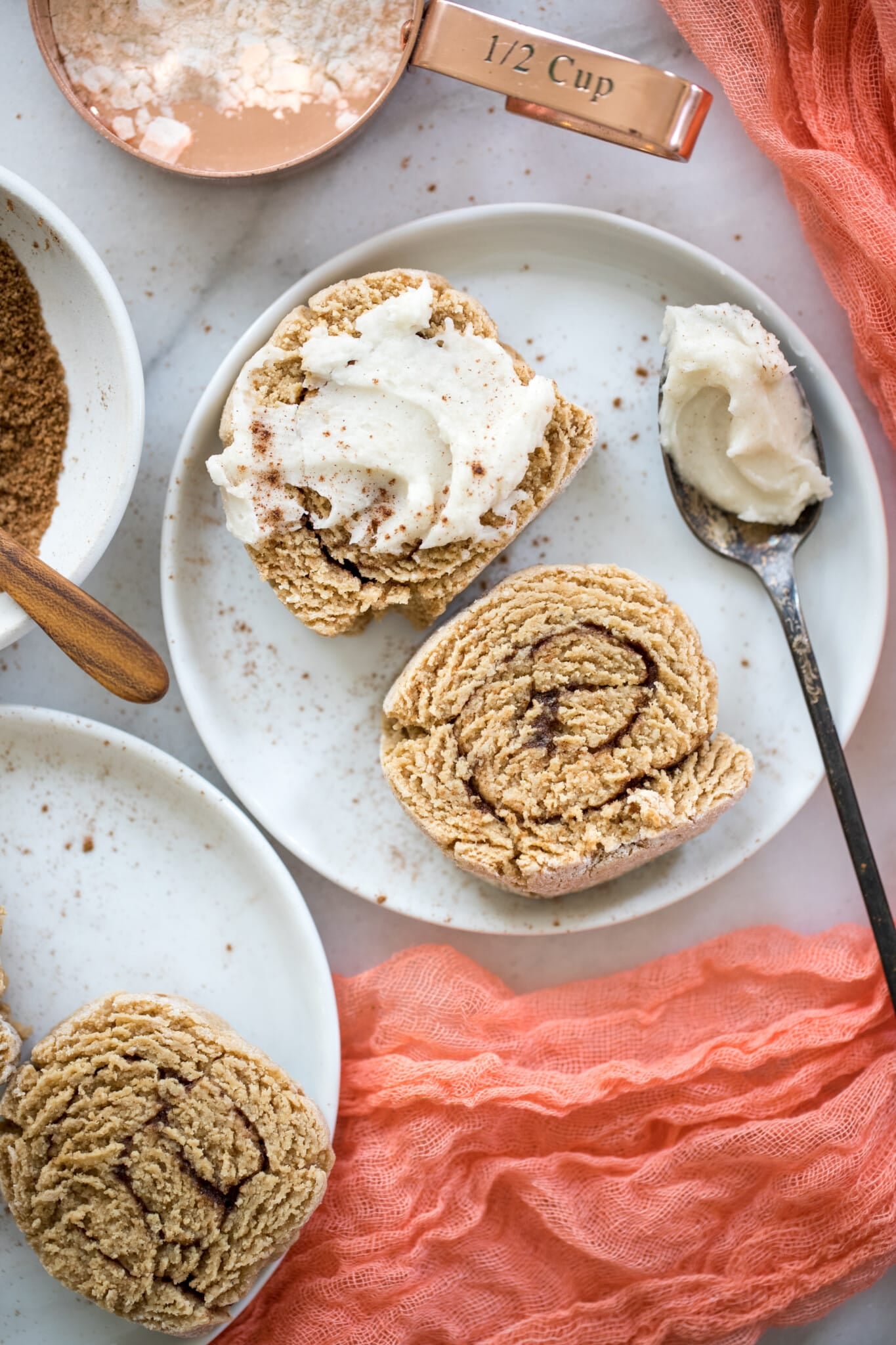 cinnamon rolls on a white plate with frosting
