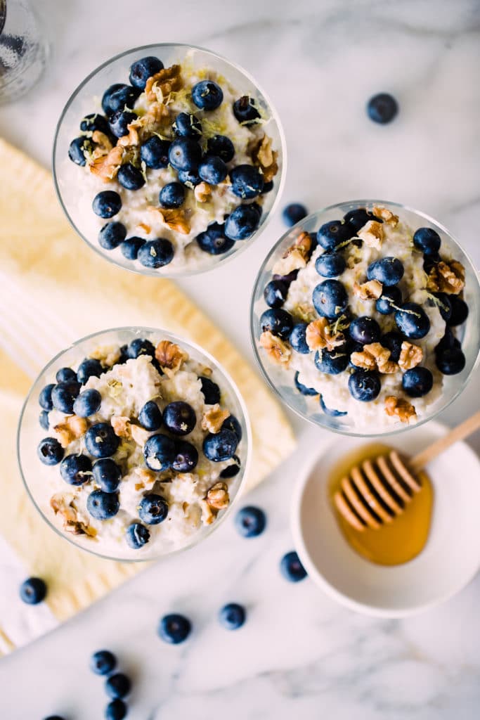 quinoa parfait in a glass parfait dish topped with blueberries