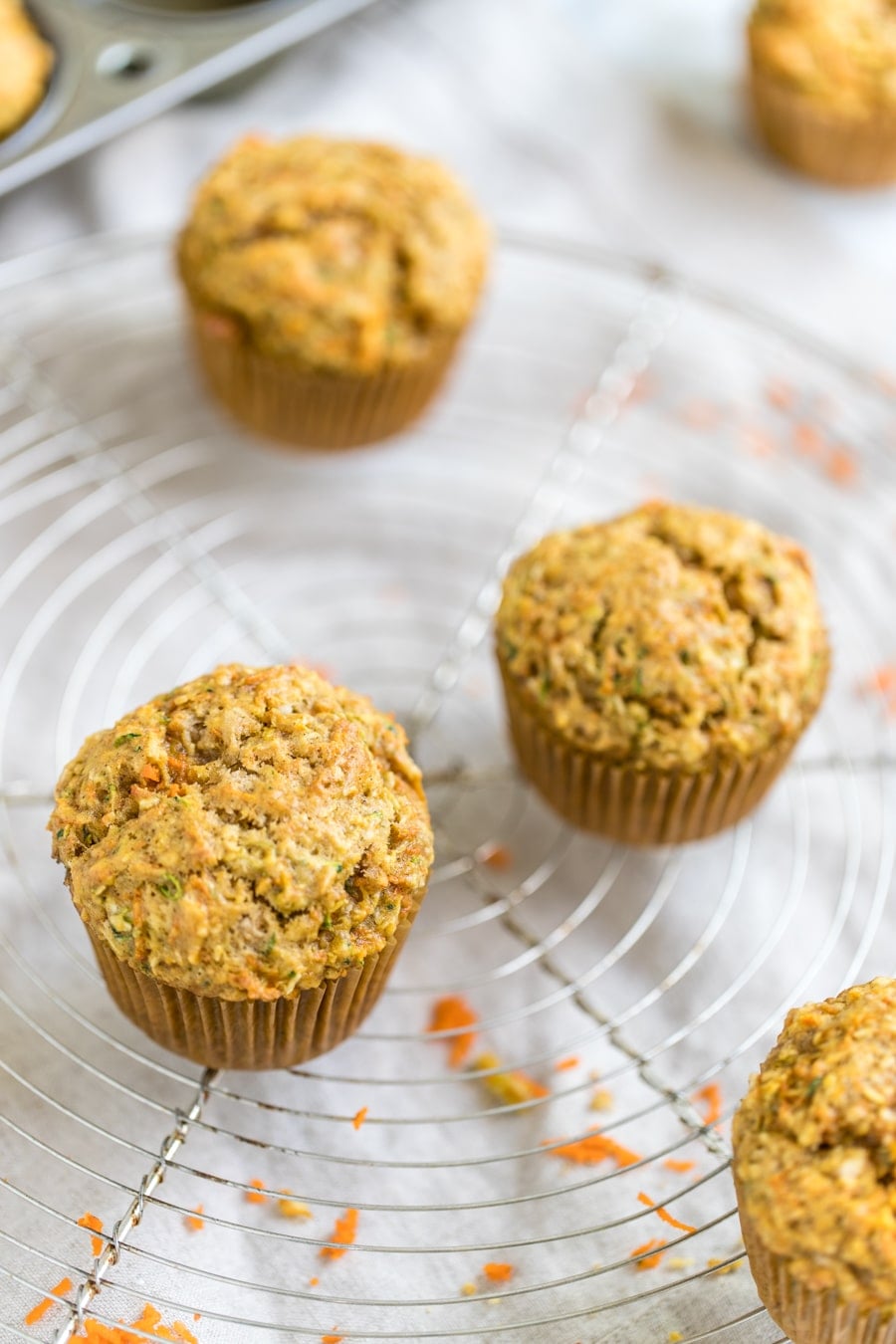 zucchini carrot muffins on a cooling rack