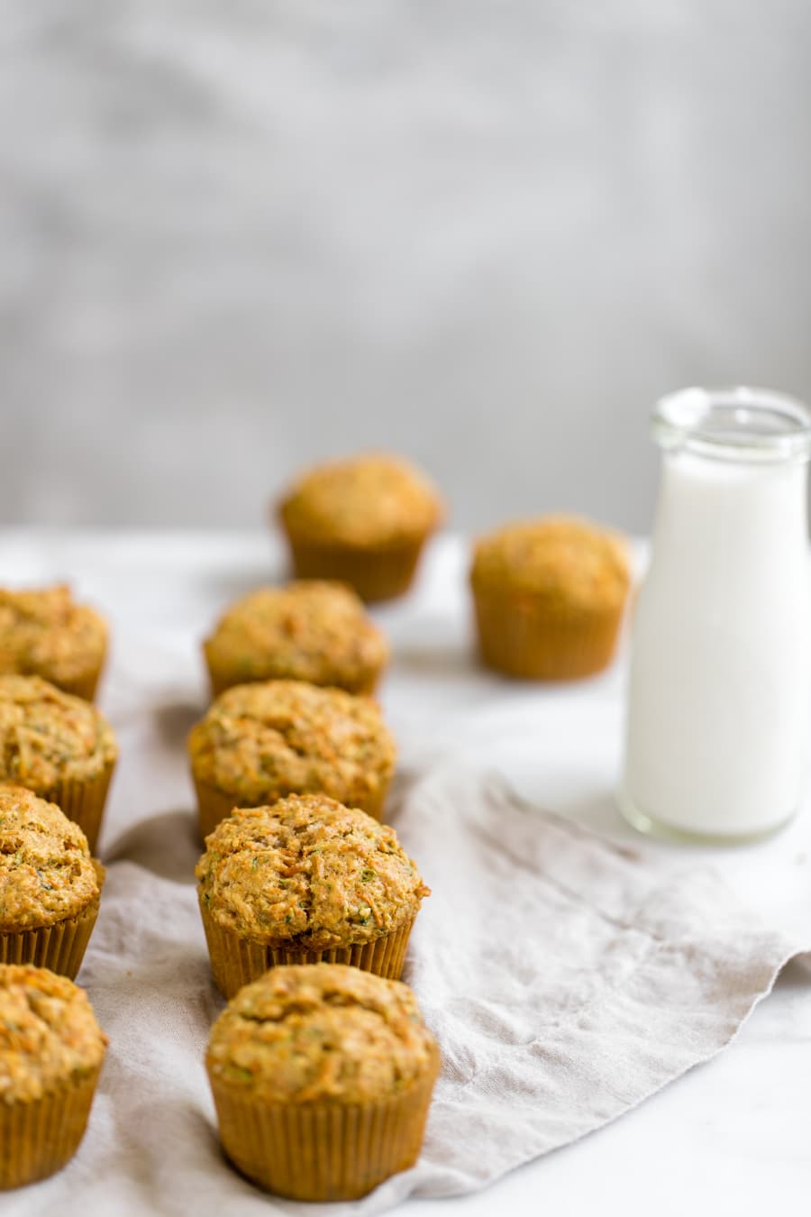 zucchini carrot muffins on a tan napkin 