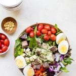 steak cobb salad on a white board