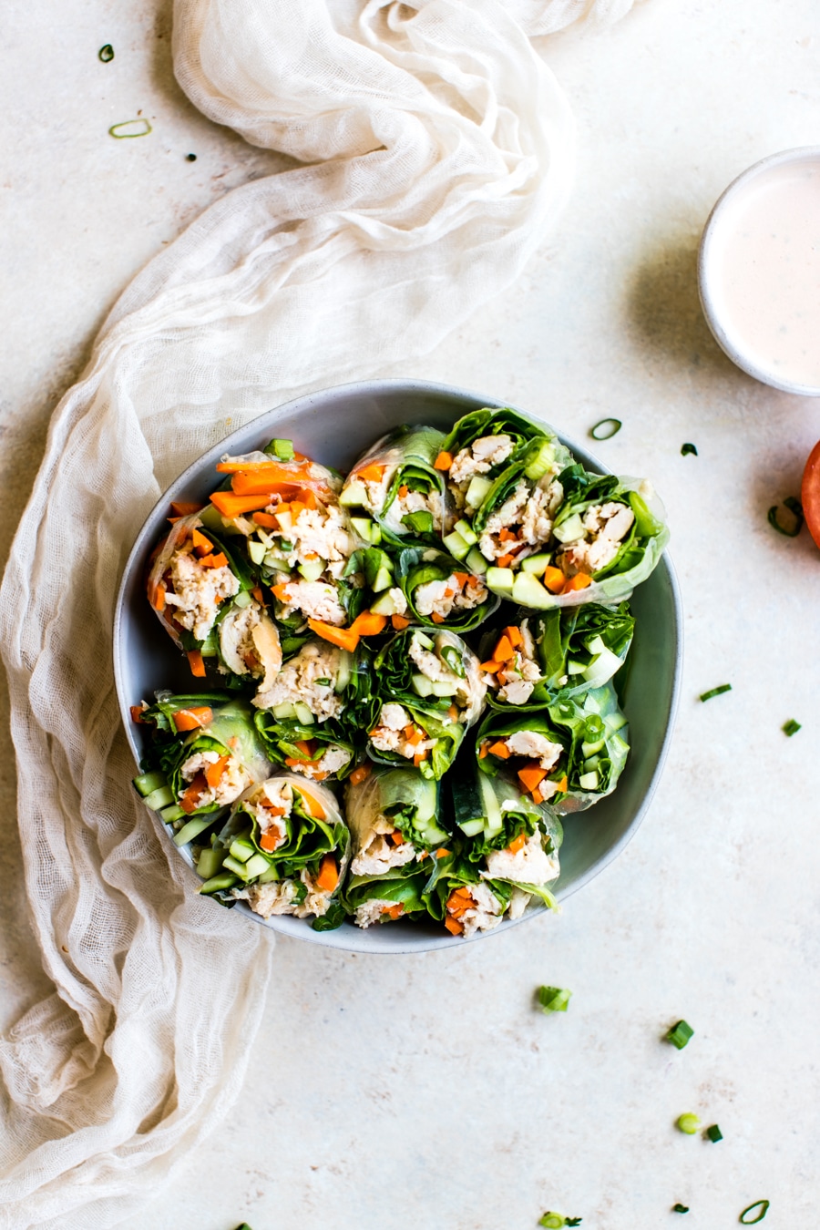 chicken summer rolls cut in half in a bowl
