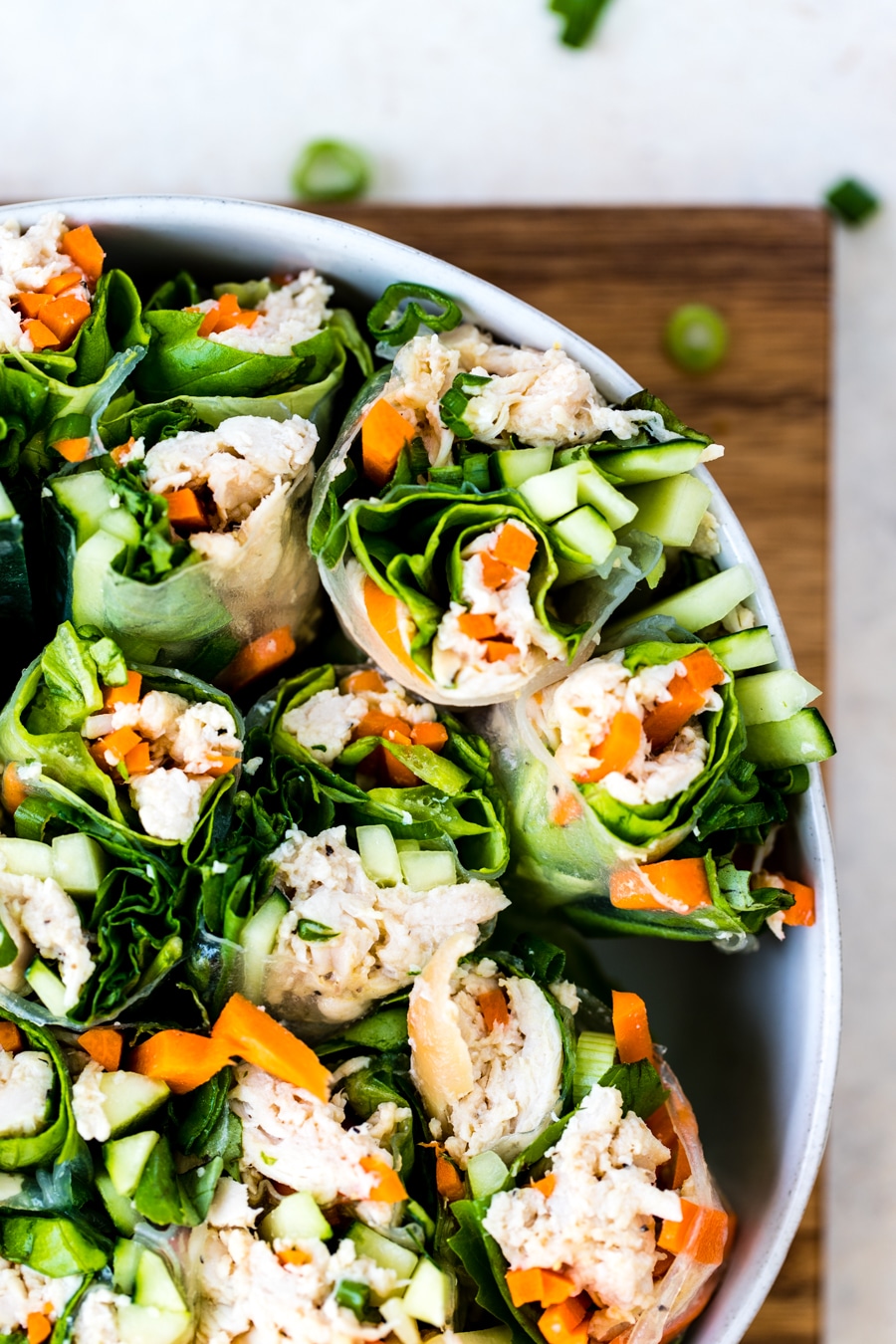 chicken summer rolls filled with veggies in a white bowl