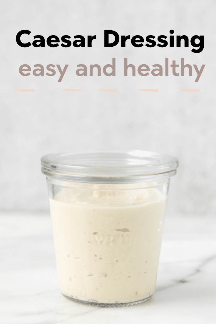Caesar salad dressing in a glass jar.