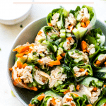 gluten free chicken summer rolls cut in half in a white bowl