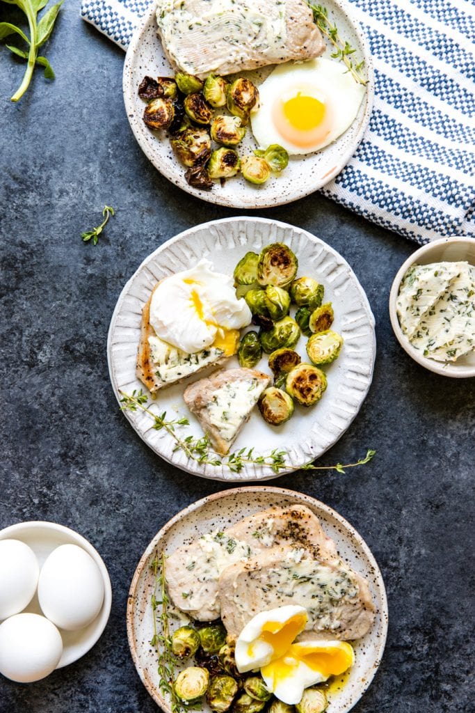 pork chops and eggs on a white plate