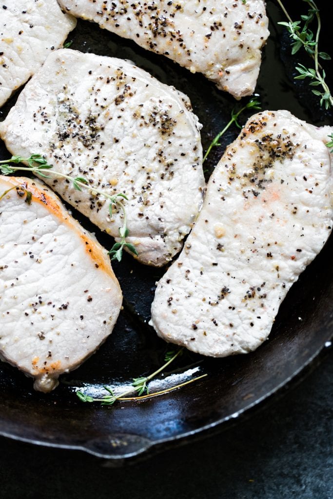 pork chops in a cast iron skillet