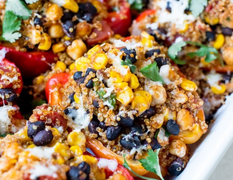 quinoa and veggies stuffed in a red bell pepper