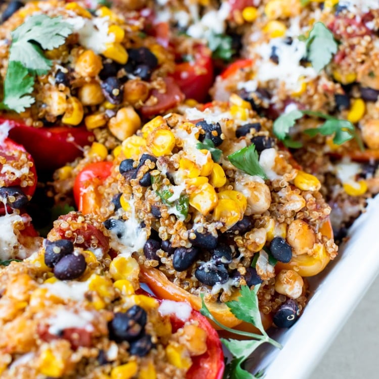 quinoa and veggies stuffed in a red bell pepper