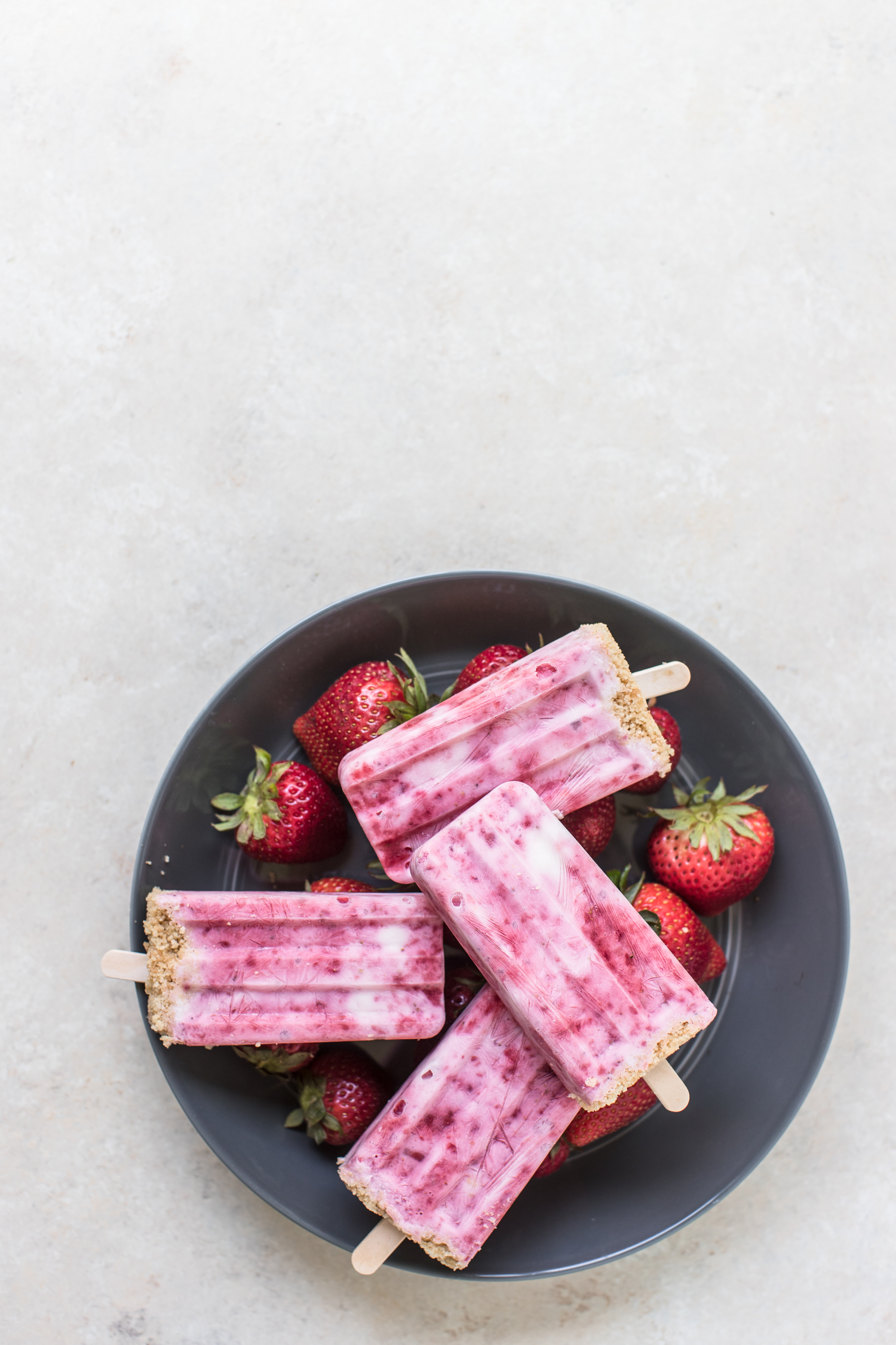 strawberry shortcake popsicles in a blue bowl