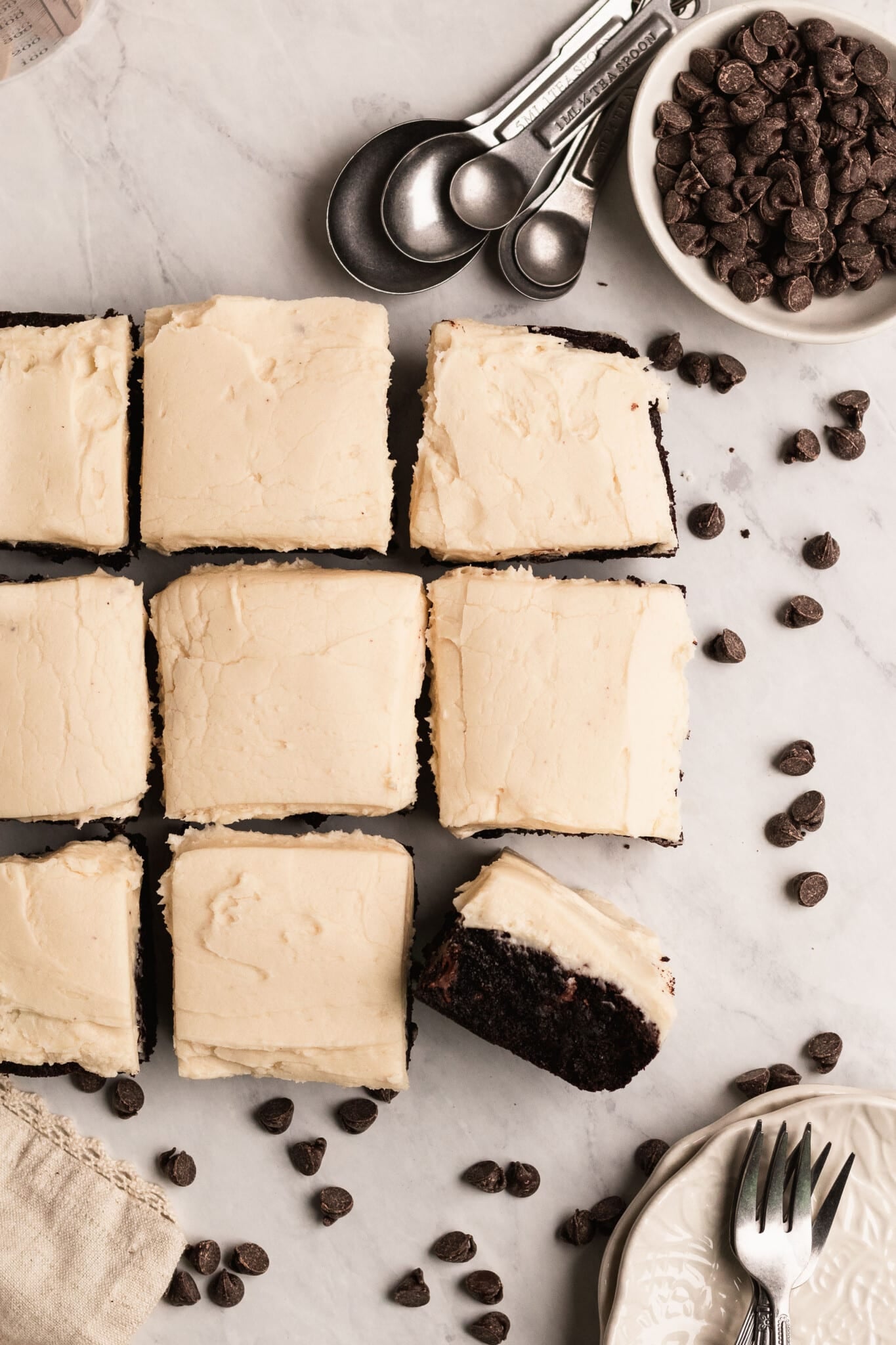 brownies on a marble board with frosting on top