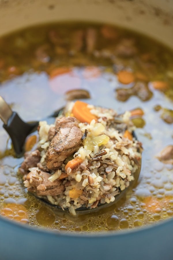 chicken shawarma soup being ladled out of a large blue stockpot