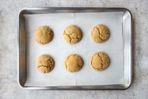 six balls of cookie dough on a baking sheet