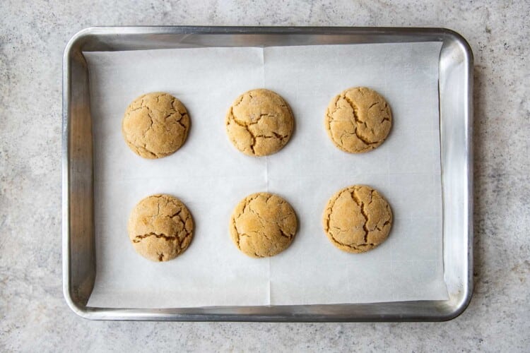 six balls of cookie dough on a baking sheet