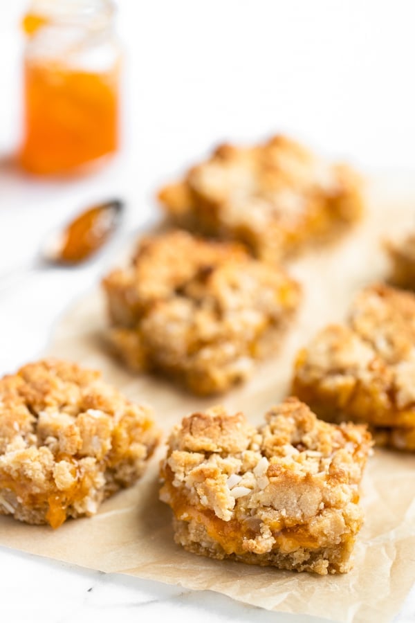 homemade apricot bars on parchment paper made with apricot preserves