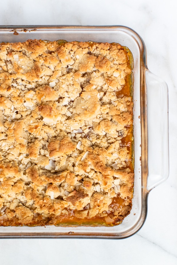 freshly baked apricot bars in an 8x8 glass baking pan