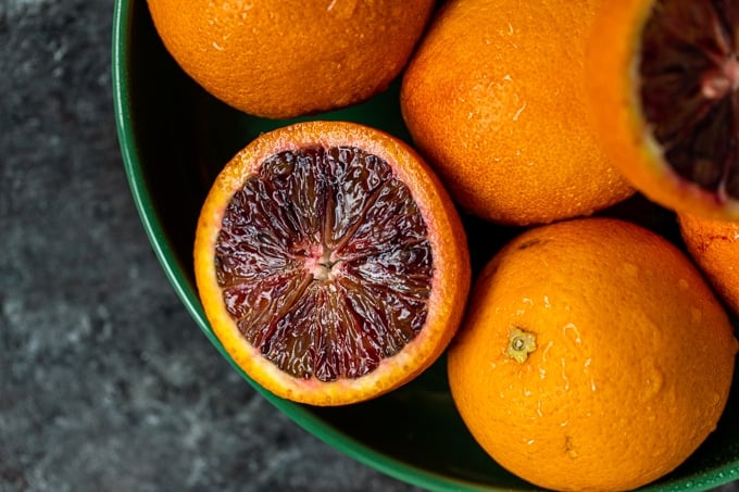 blood oranges in a green bowl